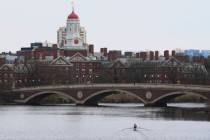 A sculler rows down the Charles River near Harvard University on April 15, 2025, in Cambridge, ...