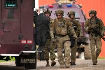 Members of law enforcement agencies search for shooting suspect, Vance Boelter, at a house Sund ...