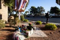 A pedestrian walks past a makeshift memorial to honor Tina Tintor, 23, at South Rainbow Bouleva ...