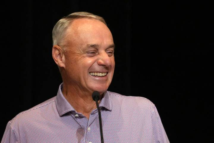 MLB Commissioner Rob Manfred laughs as he listens to a question during a news conference Tuesda ...