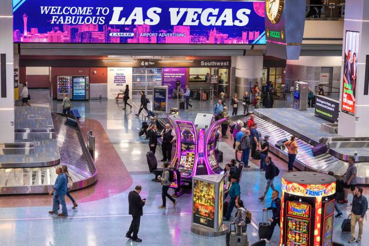 Travelers are seen at baggage claim in Harry Reid International Airport's Terminal 1 on the fir ...