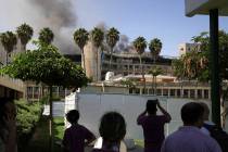 Smokes rises from a building of the Soroka hospital complex after it was hit by a missile fired ...