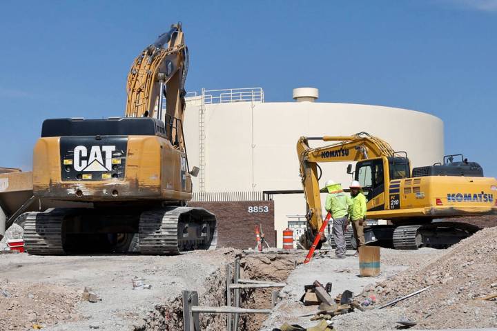 Construction workers work around City of North Las Vegas’ water tank, Friday, June 9, 2023, i ...