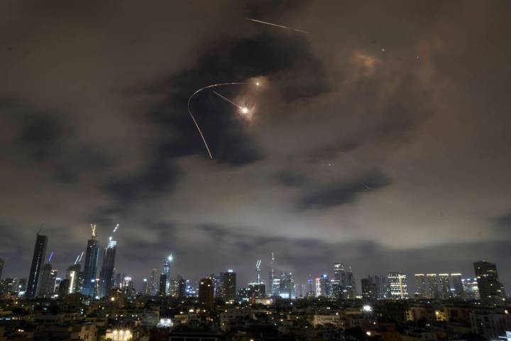 Israeli air defense system fires to intercept missiles during an Iranian attack over Tel Aviv, ...